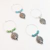 Peacock Gifts includes 4 wine charms surround by blue turquoise and silver beads