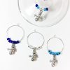 set of 4 holiday snowman wine glass tags surrounded by blue and silver glass beads