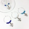 set of 4 snowman wine glass charms surrounded by glass beads